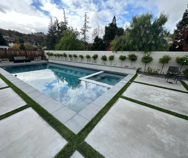 outdoor pool with concrete walkway